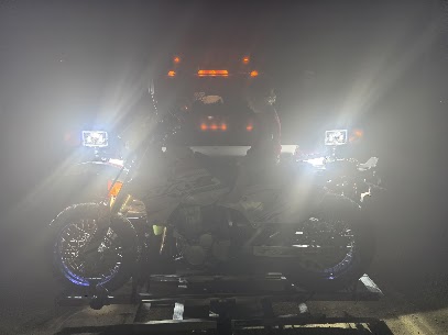 A vehicle receiving roadside assistance at night
