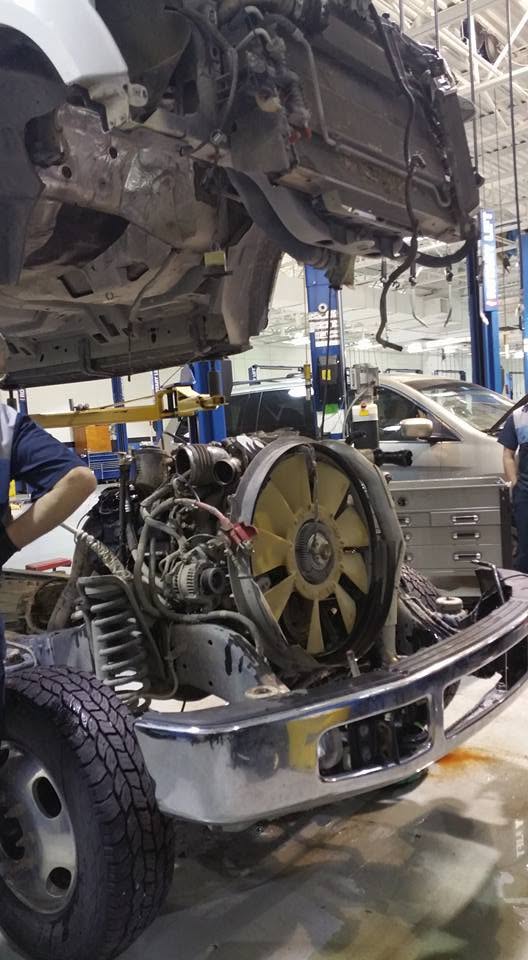 Vehicle with hood open during mechanical service
