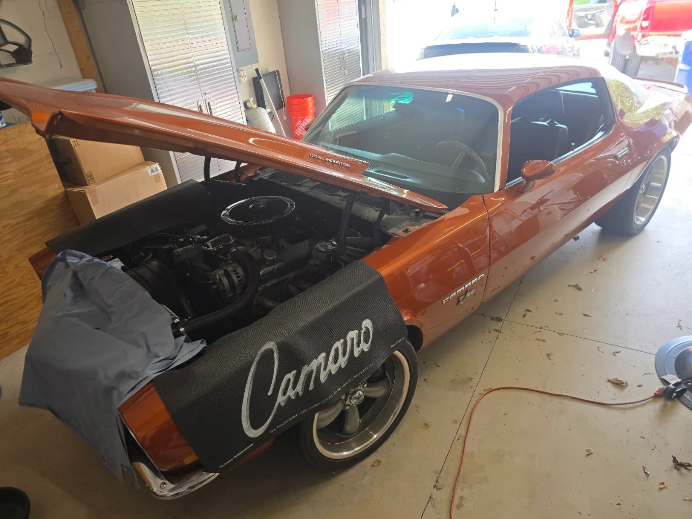 Orange vehicle in a workshop during work in progress