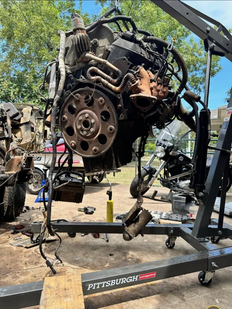 Engine being lifted from a vehicle
