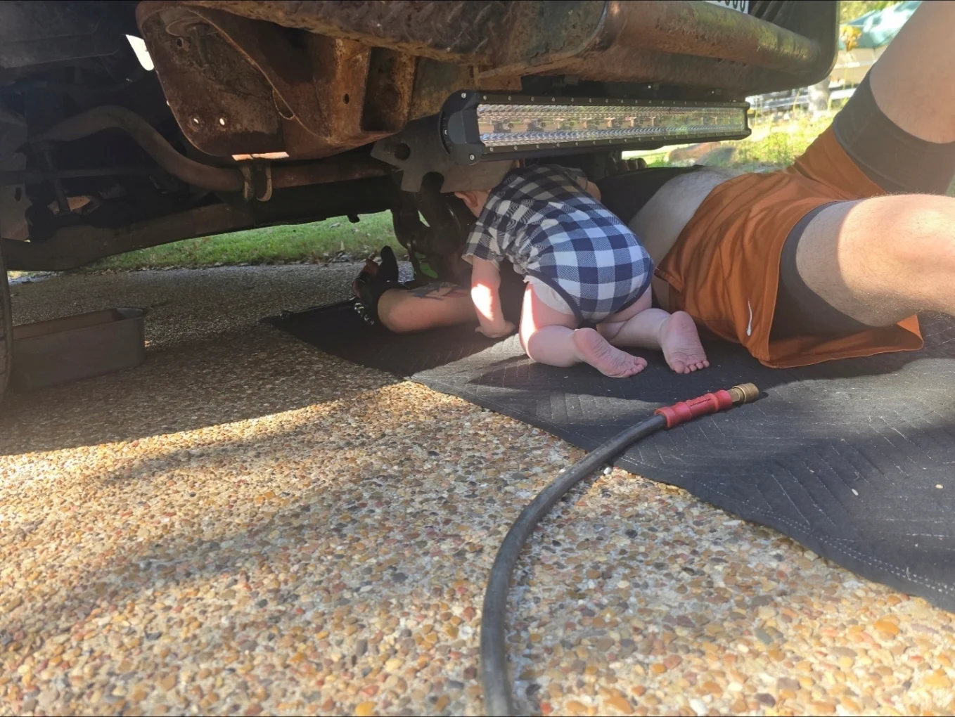 Technician working beneath a vehicle